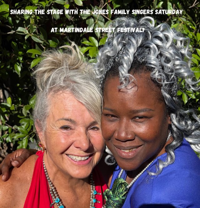 Leeann Atherton with a member of the Jones Family Singers. Sharing the stage with the Jones Family Singers Saturday at Martindale Street Festival.